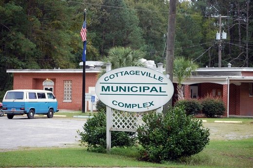 Cottageville Mayor Tim Grimsley’s VW van sits outside town hall Thursday afternoon, a day after a jury said the town owes the family of a man shot by a former police officer $60 million. Grimsely called the figure too “astronomical” to take seriously.